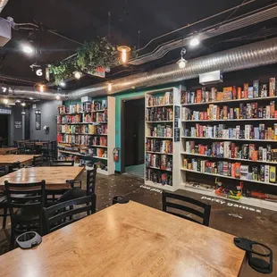 the interior of a bookstore with tables and chairs