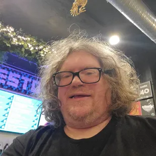 a man with glasses and a t - shirt