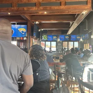 a group of people sitting at a bar