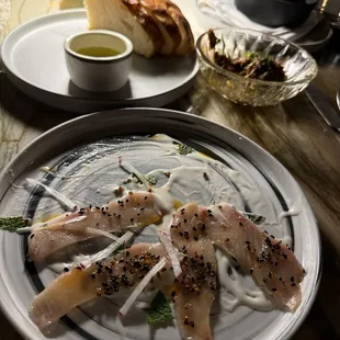 Yellowtail crudo with coconut milk sauce and black sesame seeds... don't miss this! Melts in your mouth!