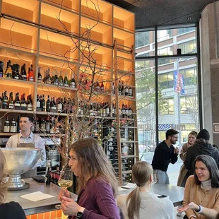 a group of people sitting at a bar