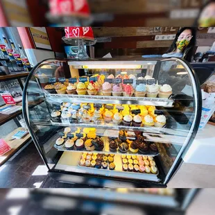 a display case full of cupcakes