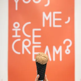 a hand holding an ice cream cone