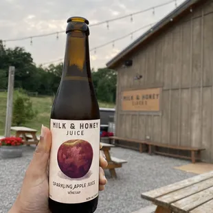 a hand holding a bottle of cid