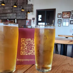 two glasses of beer on a table