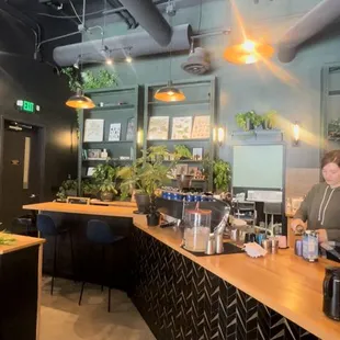 a man standing at a counter in a restaurant