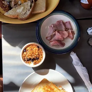 Southwestern skillet, side of ham, yogurt parfait, and egg sandwich