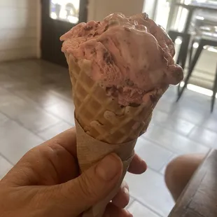 Red velvet ice cream in a sugar cone