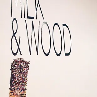 Thai tea popsicle with dark chocolate and sprinkles