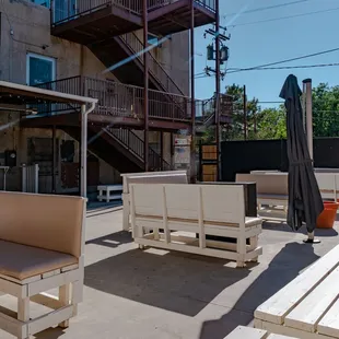 a patio with tables and chairs