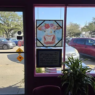 Cute cows check out that sandwich on the board.