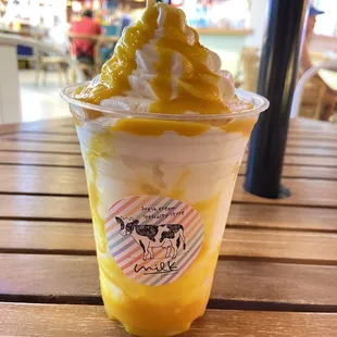an ice cream sundae with mango and whipped cream