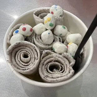 a bowl of rolled up doughnuts