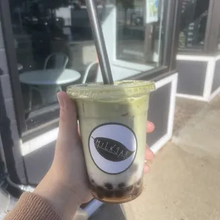 a hand holding a cup of coffee