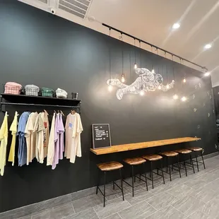 a black wall with clothes hanging on it