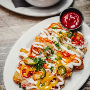 a plate of fries and a bowl of ketchup