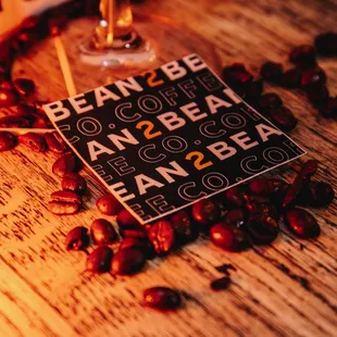 a glass of wine and a sign on a table