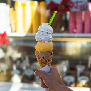 a hand holding an ice cream cone