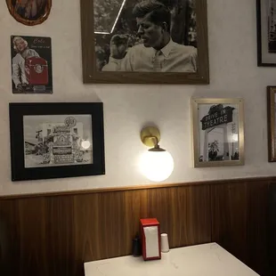 View of the wall next to the booth which features fun photos. Additionally, each booth has its own light.