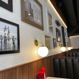 a table with a red candle and a picture on the wall