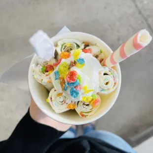 a person holding a cup of ice cream