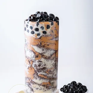 a glass of iced coffee and a bowl of blackberries