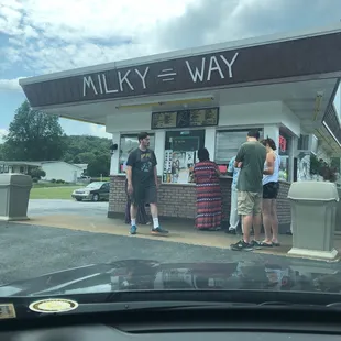 a group of people standing in front of a store