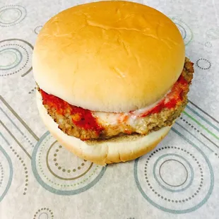 a hamburger with meat and tomato sauce