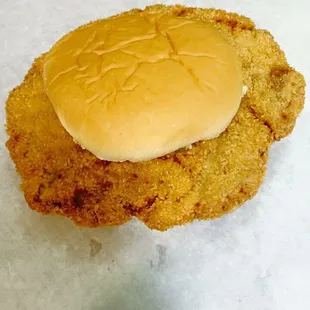 a chicken sandwich on a piece of paper