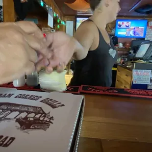 a woman serving a pizza