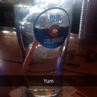 a glass of water with a straw in it