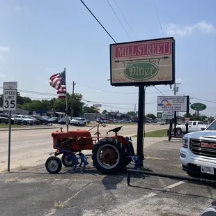 a tractor parked in front of a sign