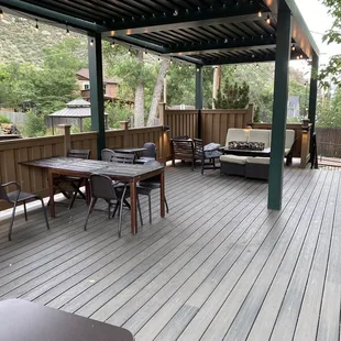 First elevated deck with comfy-couch. The stairs to the right of the couch lead to the creek seating.