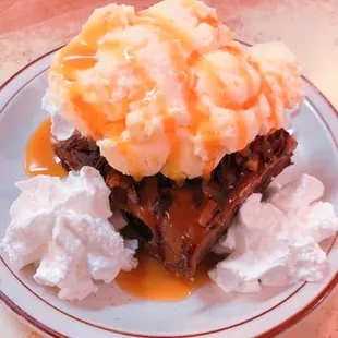 a plate of food with ice cream and caramel sauce