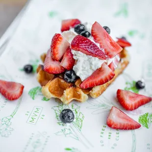 a waffle with strawberries and blueberries