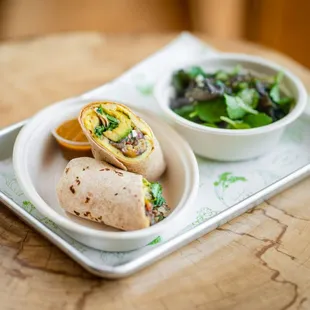 a burrito and a bowl of salad