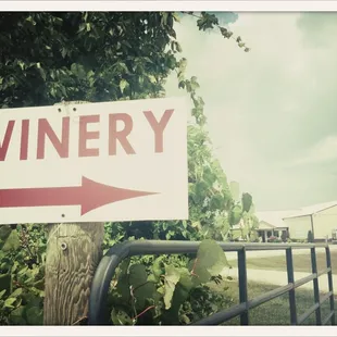 a sign pointing to a winery
