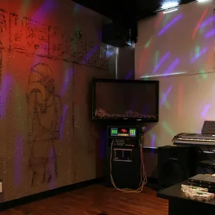 a room with a piano and a tv