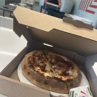 Two types of pepperonis and mozzarella on fresh dough