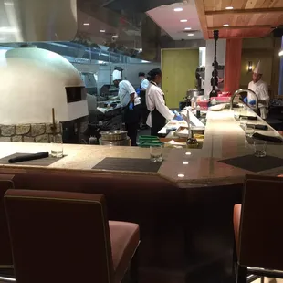 Open kitchen that has seats for viewing the kitchen.