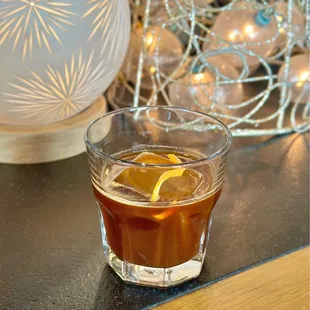 Old Fashioned(espresso, bitters, and simple syrup, shaken and served over a cocktail cube, w/an orange twist)