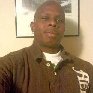 a man in a brown polo shirt