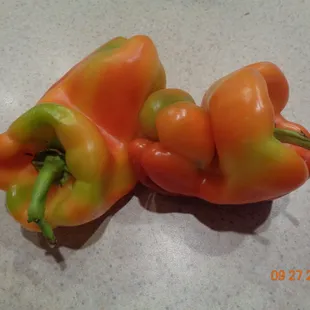 two peppers on a counter