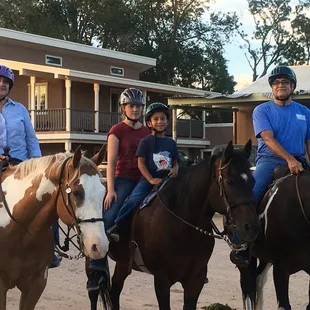 Grandma, Grandpa, and their youngest grandson back from a trail ride.