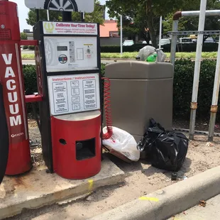 No sign Broken air machine and overflow piles of trash in can