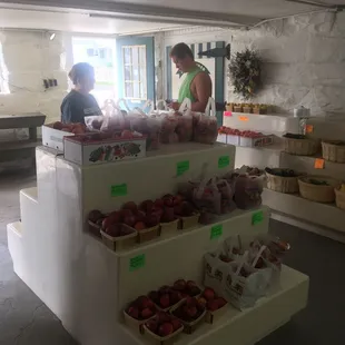 a woman and a child shopping for apples