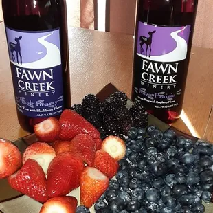 a plate of strawberries, blueberries, and blackberries