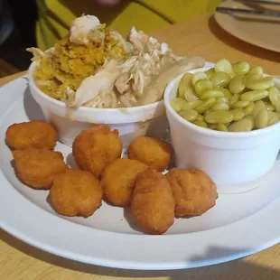 Chicken and corn bread dressing, corn fritters, and Lima beans.