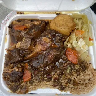 Small size of oxtails, rice and beans, cabbage, and fried dumpling.