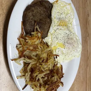 Three over medium eggs, hash browns and sausage
